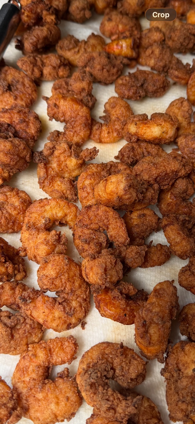 Golden-brown fried shrimp resting on a lined tray